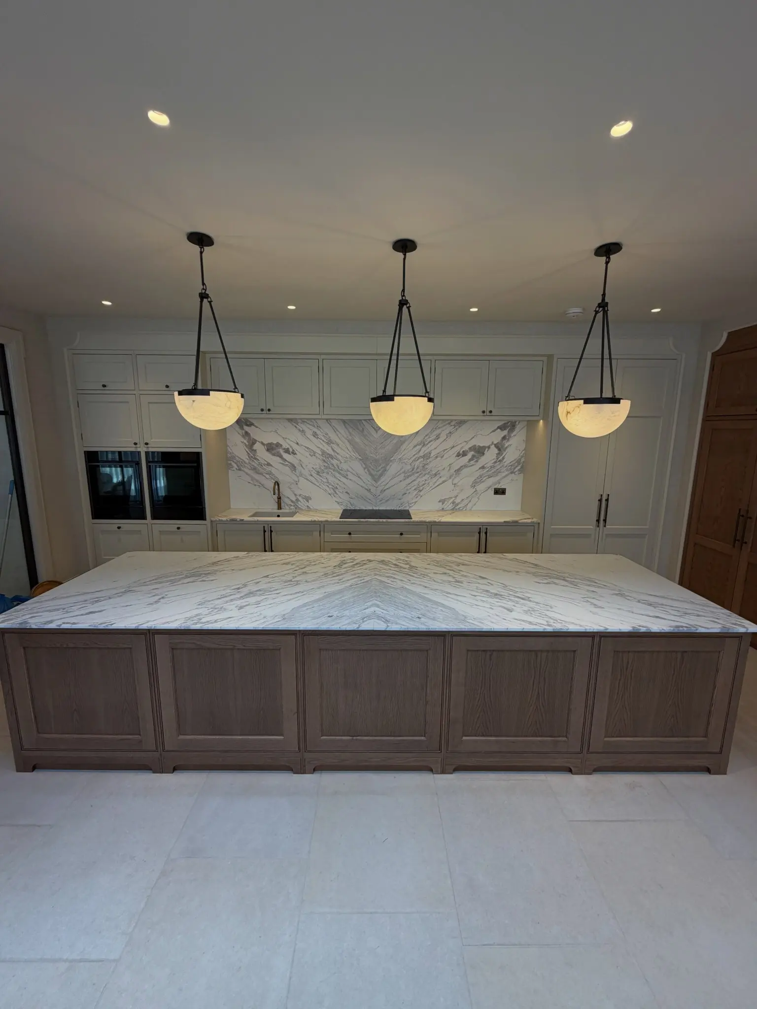 Fantasy Brown marble kitchen island with book-matched splashback
