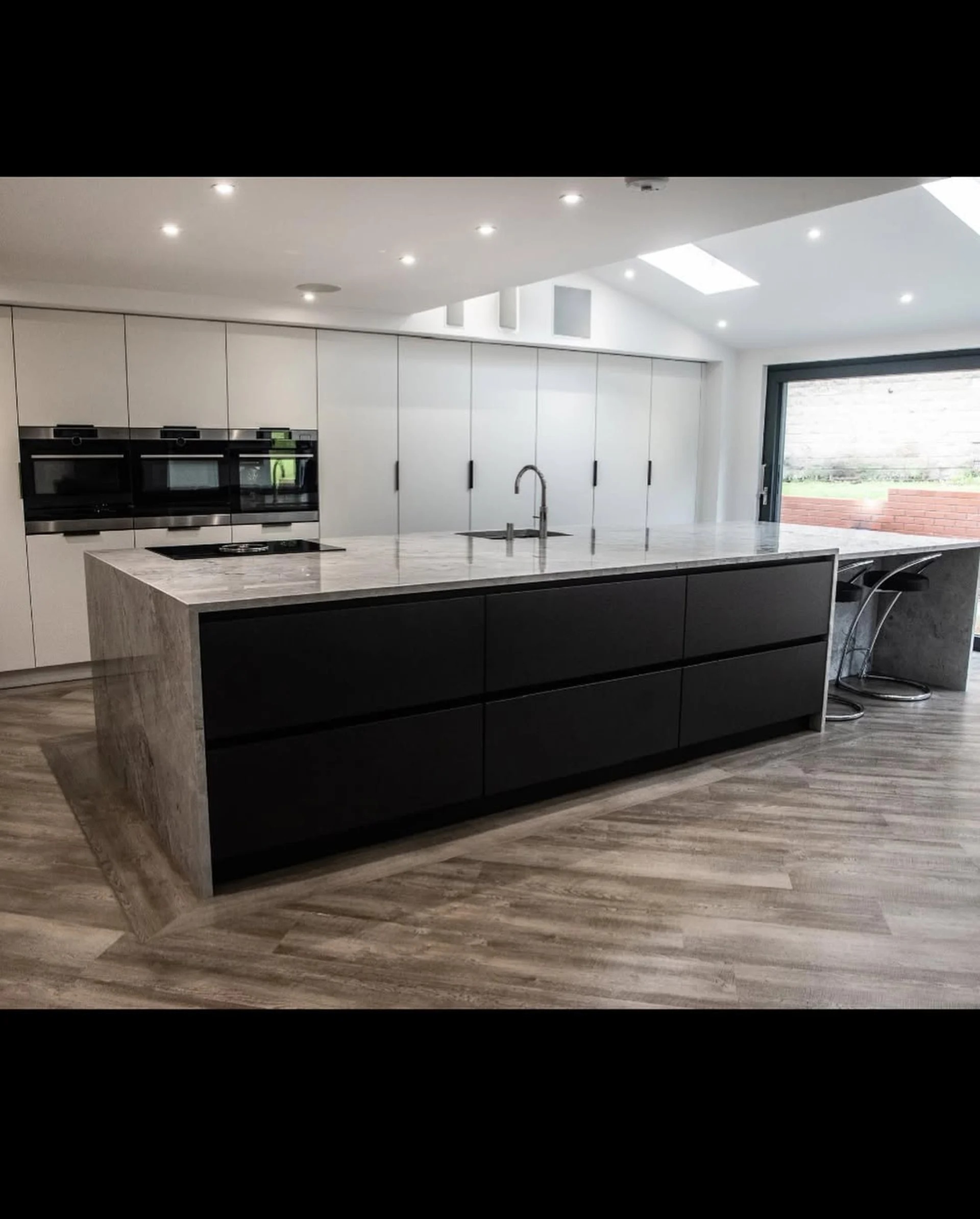 Grey granite waterfall island installed for an Ashington kitchen project