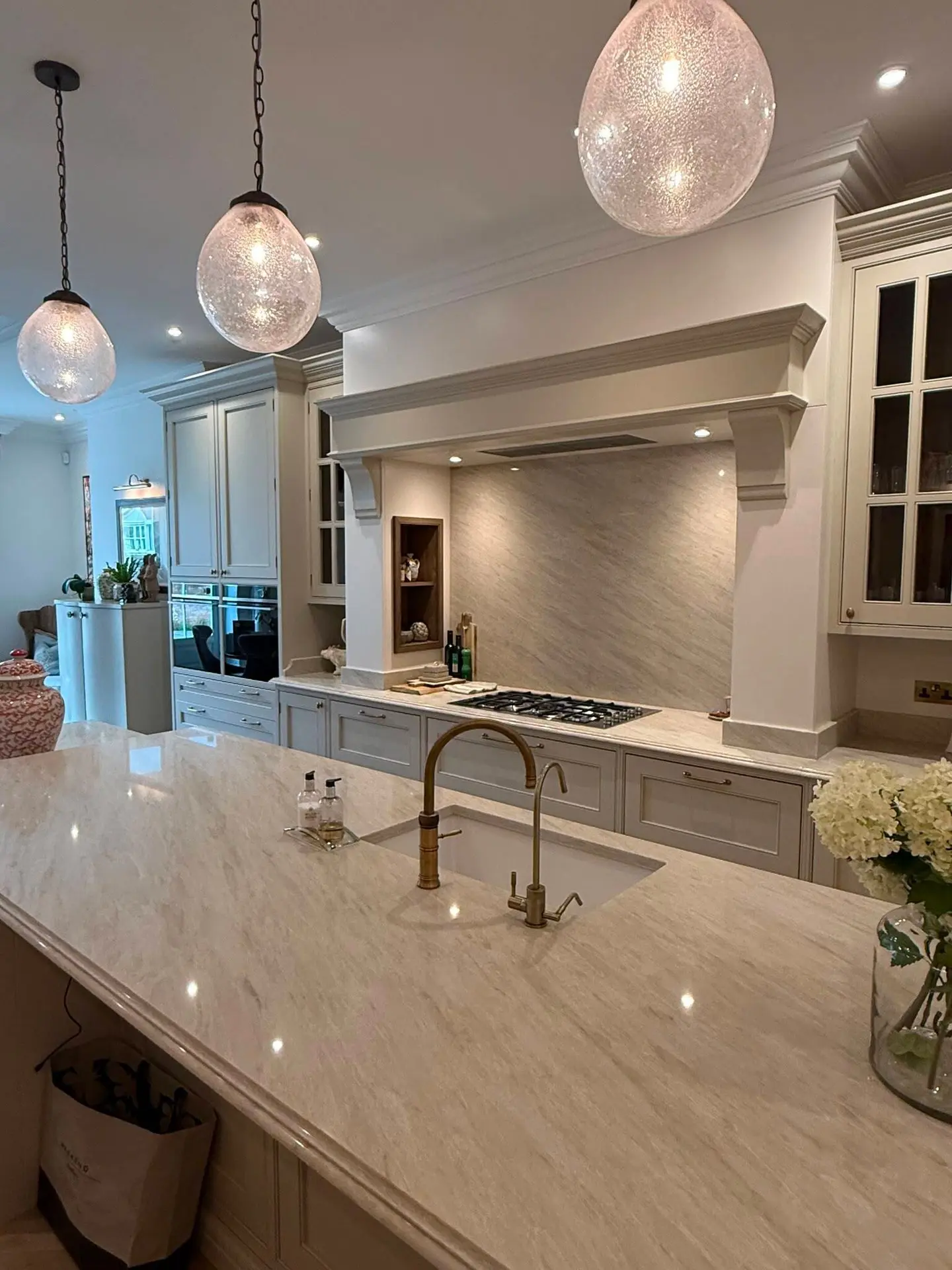 Light quartz island and splashback shown as Bishop Auckland kitchen inspiration