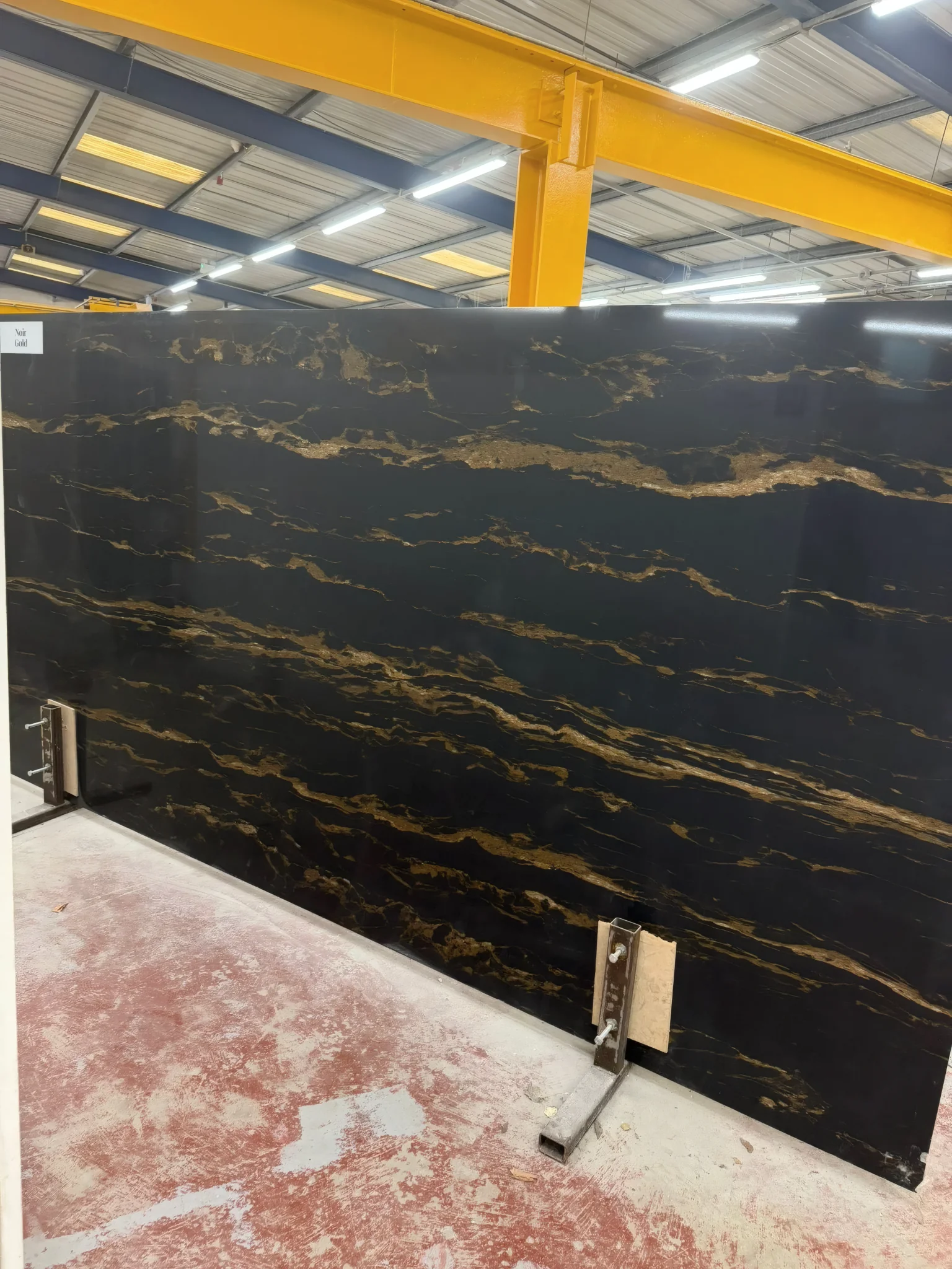 Noir Gold quartz slab with dark background and gold-style veining