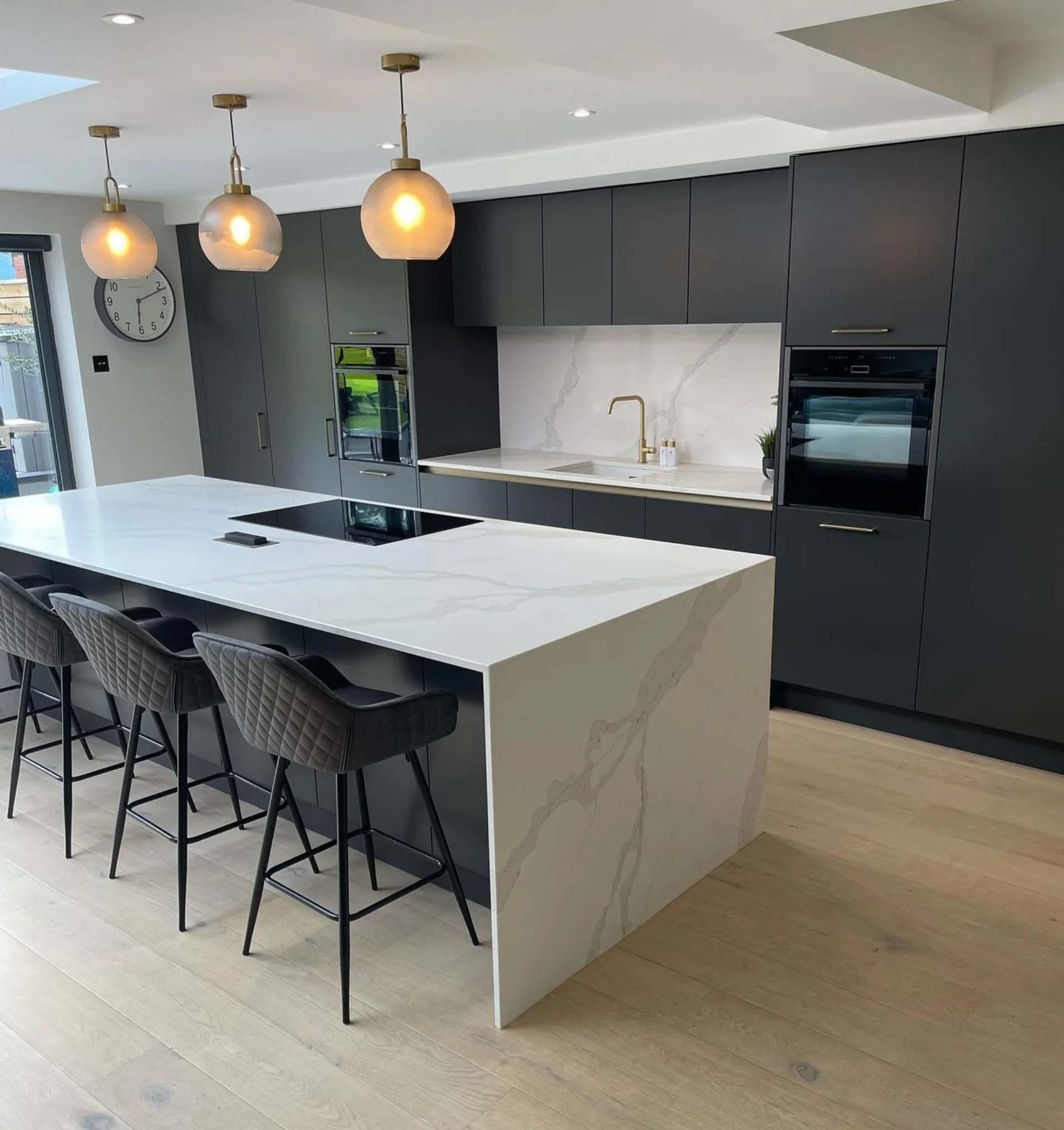 Calacatta-style quartz waterfall kitchen island supplied by RH Stone Surfaces